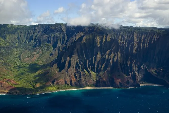 The Na Pali Coast seen from the air under a blue sky
